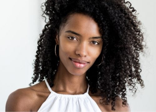 Portrait of a curly hair young lady | Dysport Injectable | Avail Aesthetics in Cary, Raleigh & Wake Forest, NC