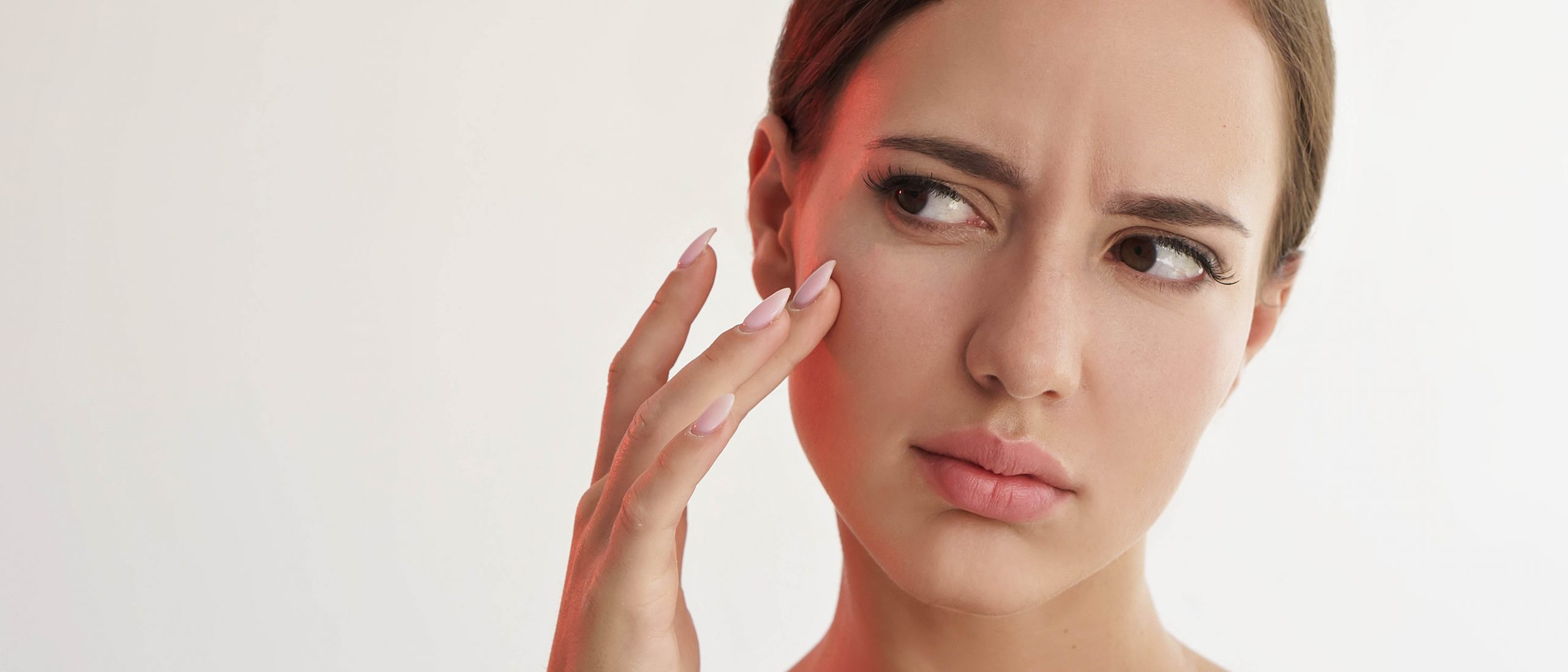 Young Beauty Woman Checking Her Dull Skin | Avail Aesthetics in Raleigh, NC
